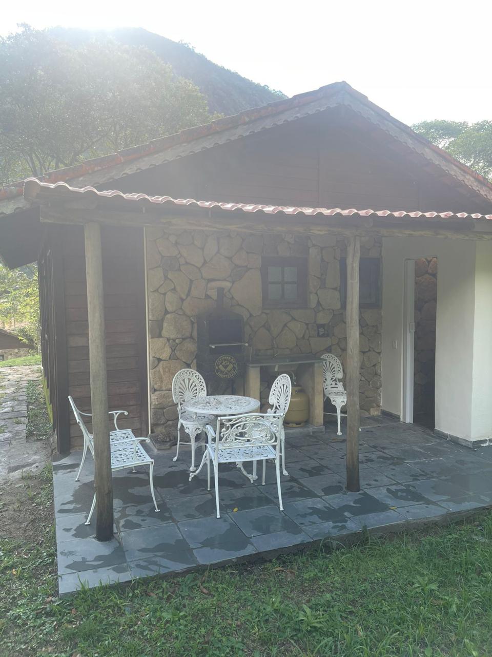 Fachada de pedra e varanda da pousada